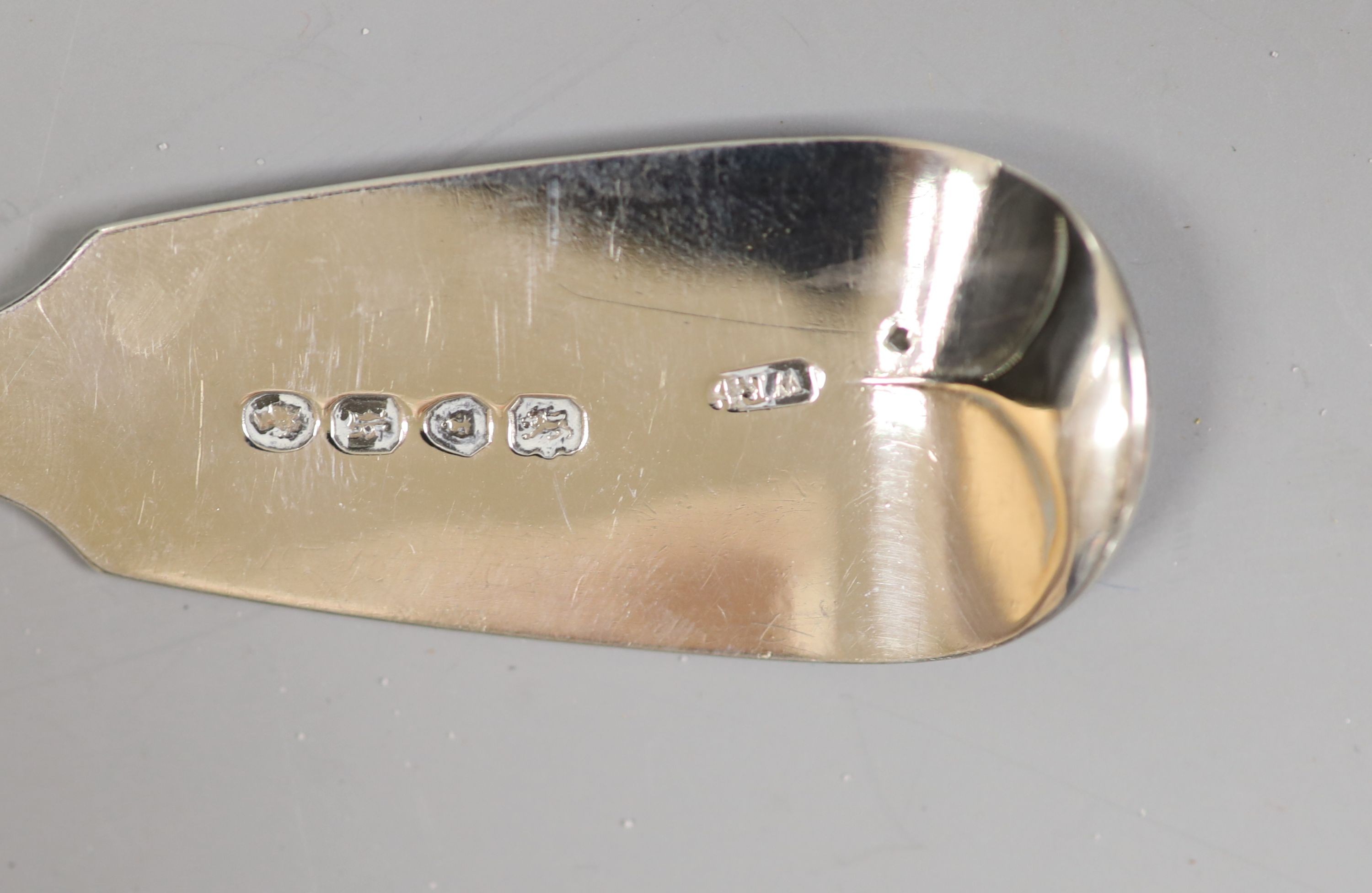 A pair of Victorian silver fish servers with loaded handles, Sheffield, 1853 and a Victorian silver fiddle pattern fish slice.